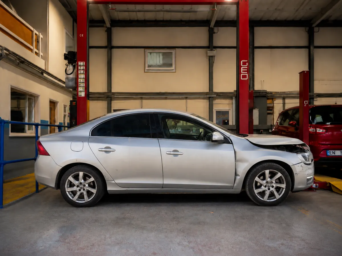 Silver Volvo S60 saloon photographed side-on in a workshop