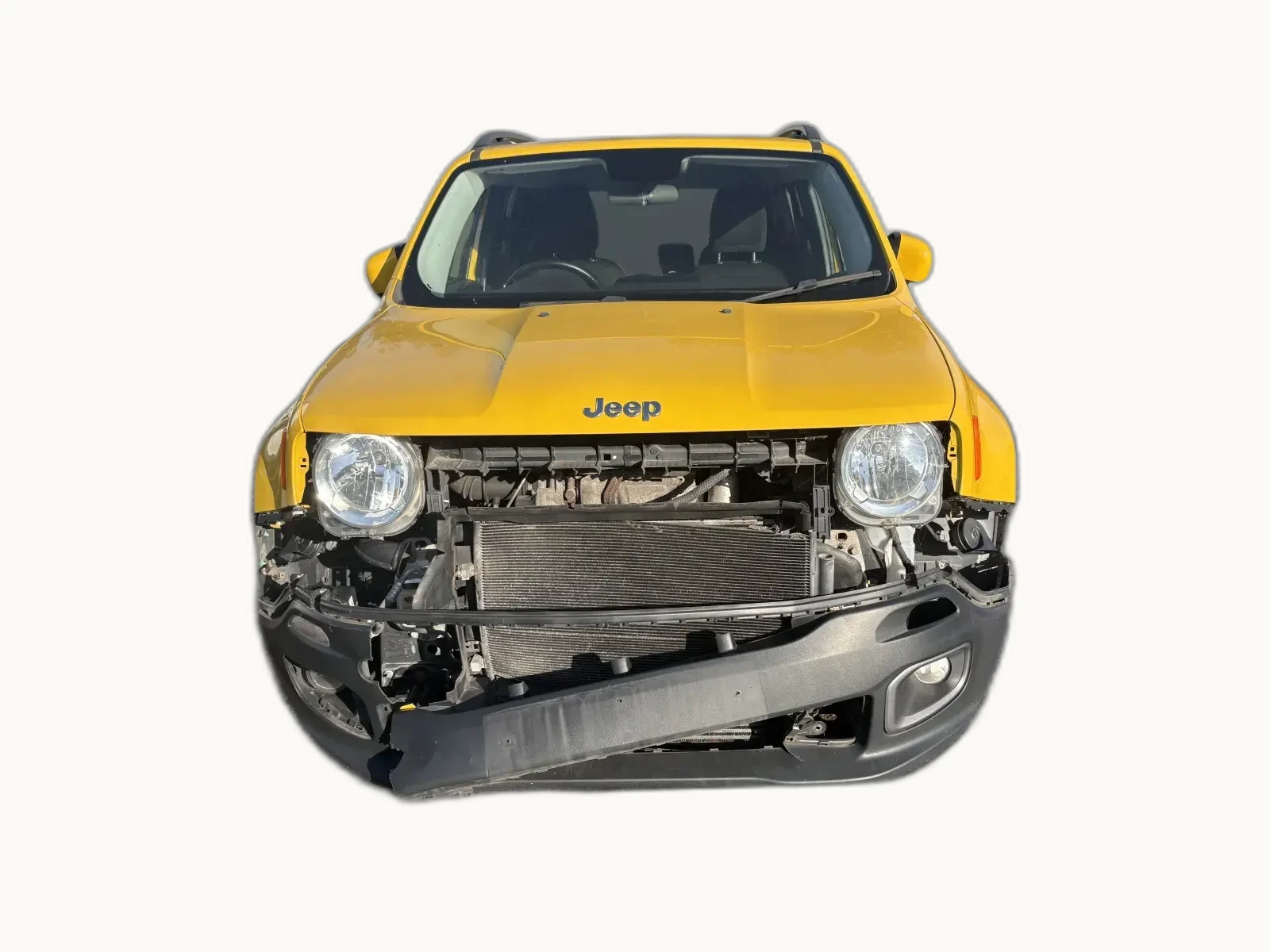 Yellow Jeep Renegade with severe front-end impact damage. Bonnet crumpled, grille smashed inward, exposed engine bay